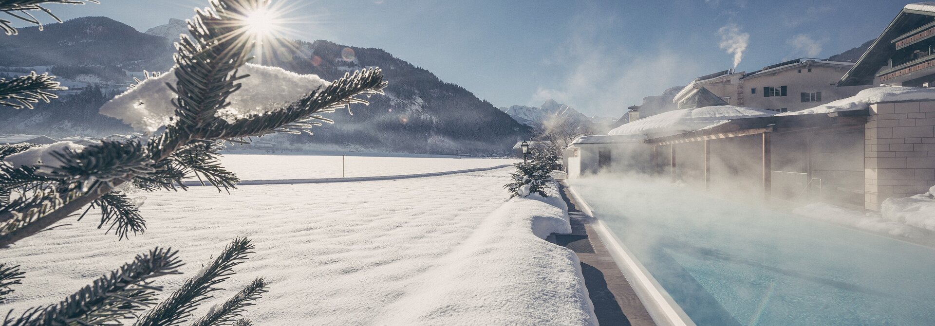 Outdoor pool in snowy winter landscape | Wellnesshotel Theresa, Vacation in Zell am Ziller